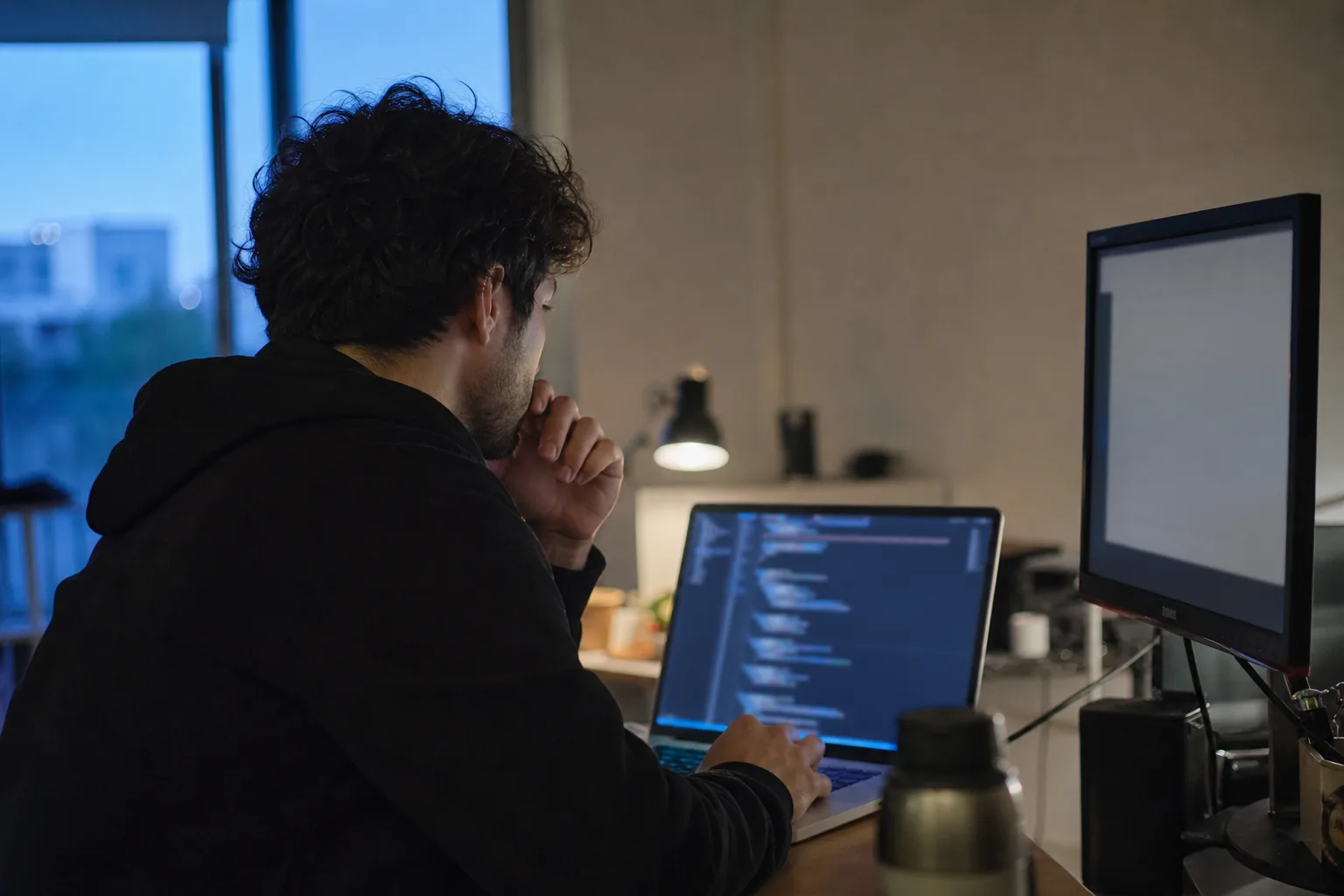 Gig platform operations lead reviewing a weekly contractor payout batch on a laptop in a small office